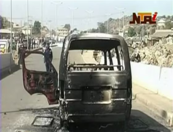 A&nbsp;burned van is seen on a road following violence in Jos, Nigeria, on Dec. 25. Dozens of people were killed over the holiday weekend in attacks across Nigeria, including 32 that died in central Nigeria in a series of bomb blasts in the worst violence to hit the region in months.